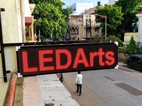 Red LED scrolling message board installed on a building front by LED Arts